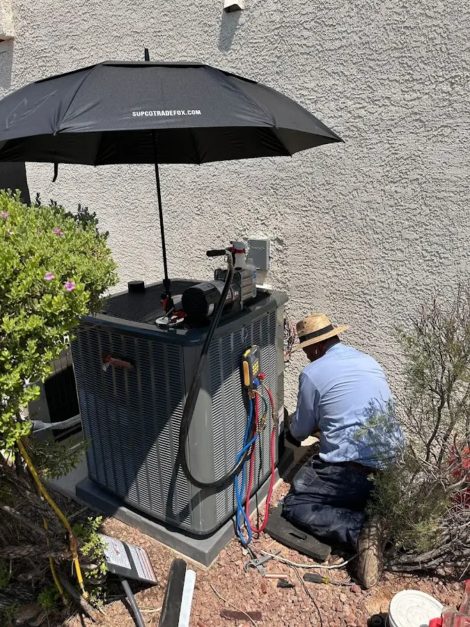 HVAC technician performing outdoor AC maintenance in New Haven